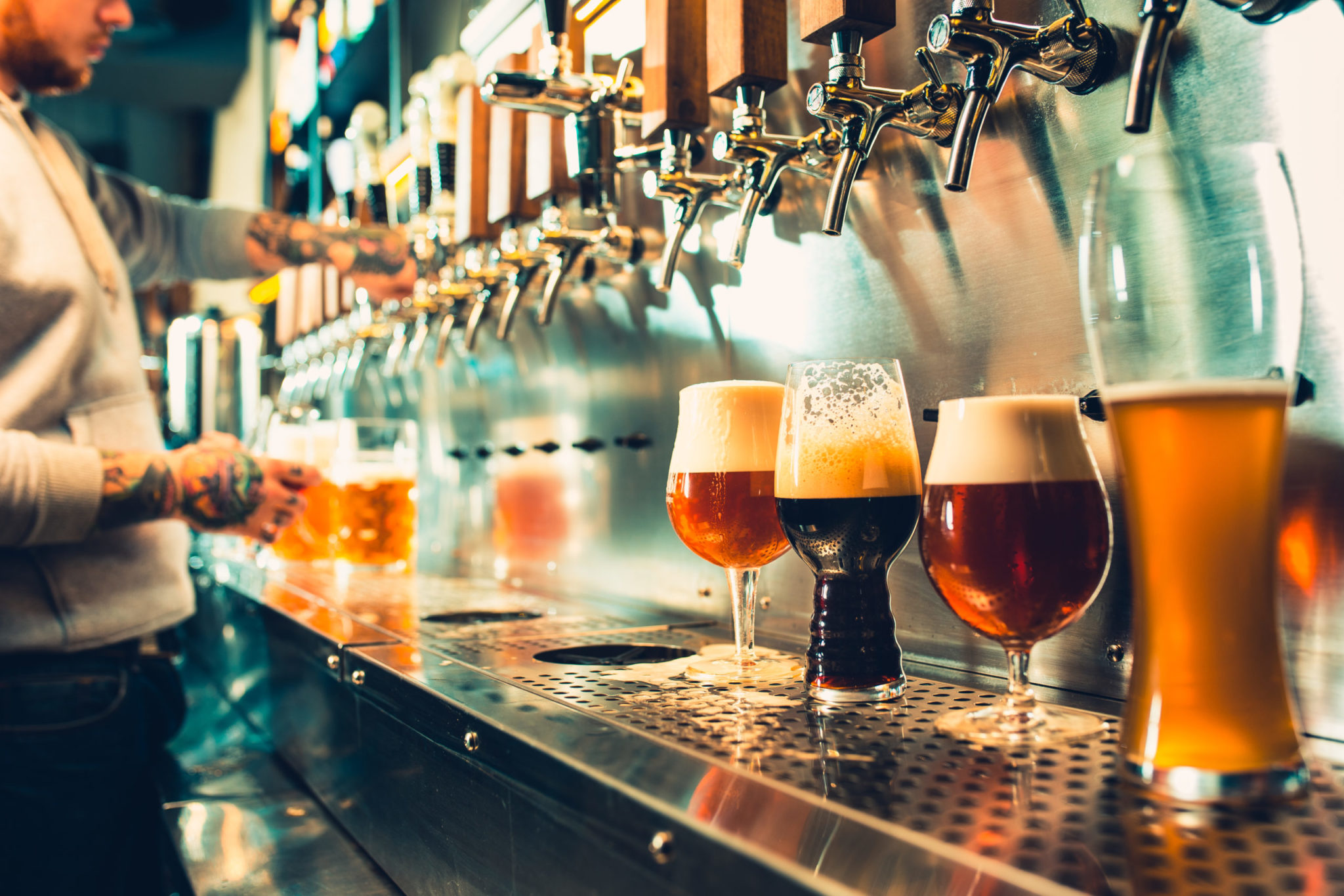 Bartender gets drinks ready at the bar